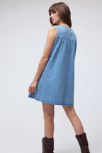 Woman wearing a blue dress on a white background