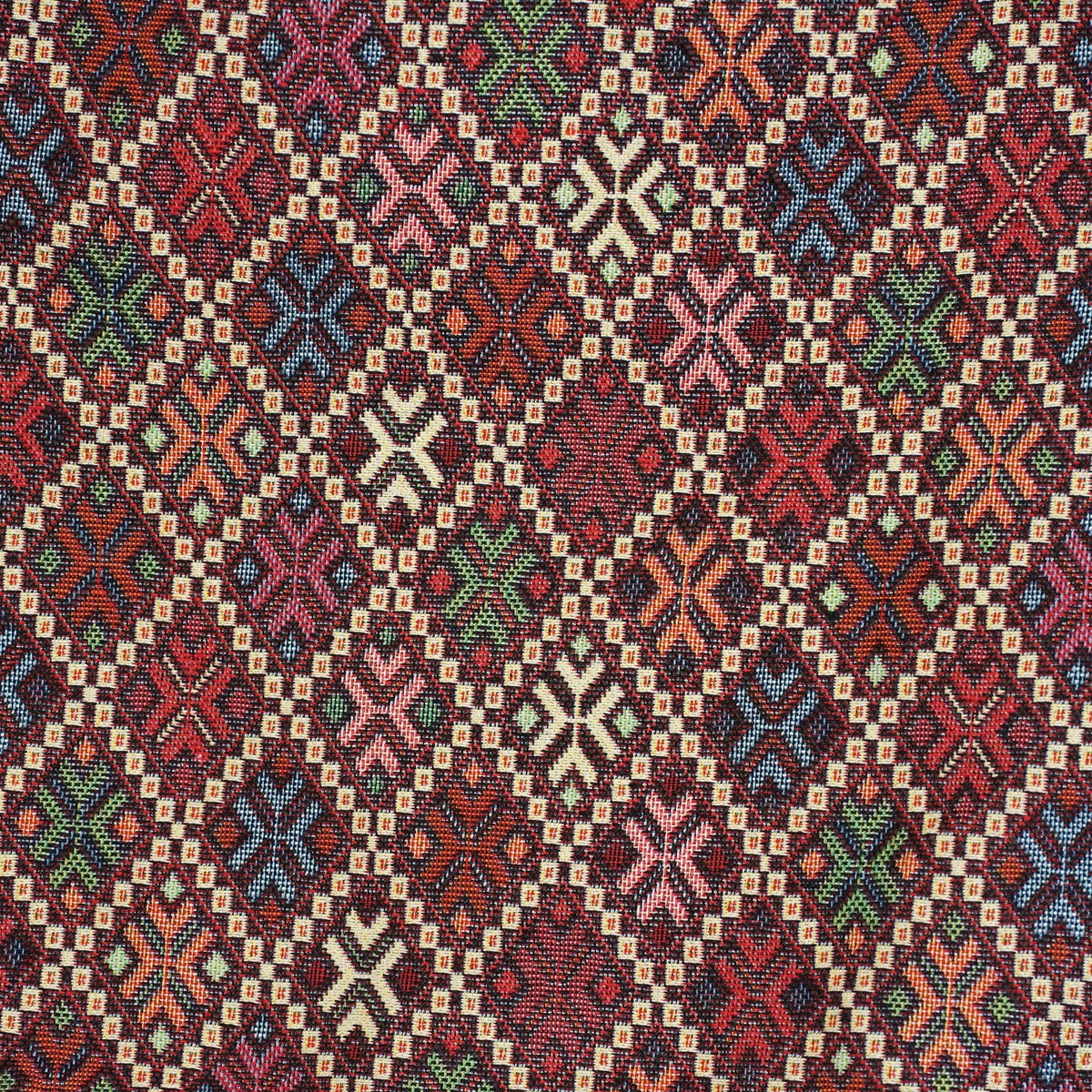 Close-up of the woven kilim-style diamond and cross pattern on burgundy