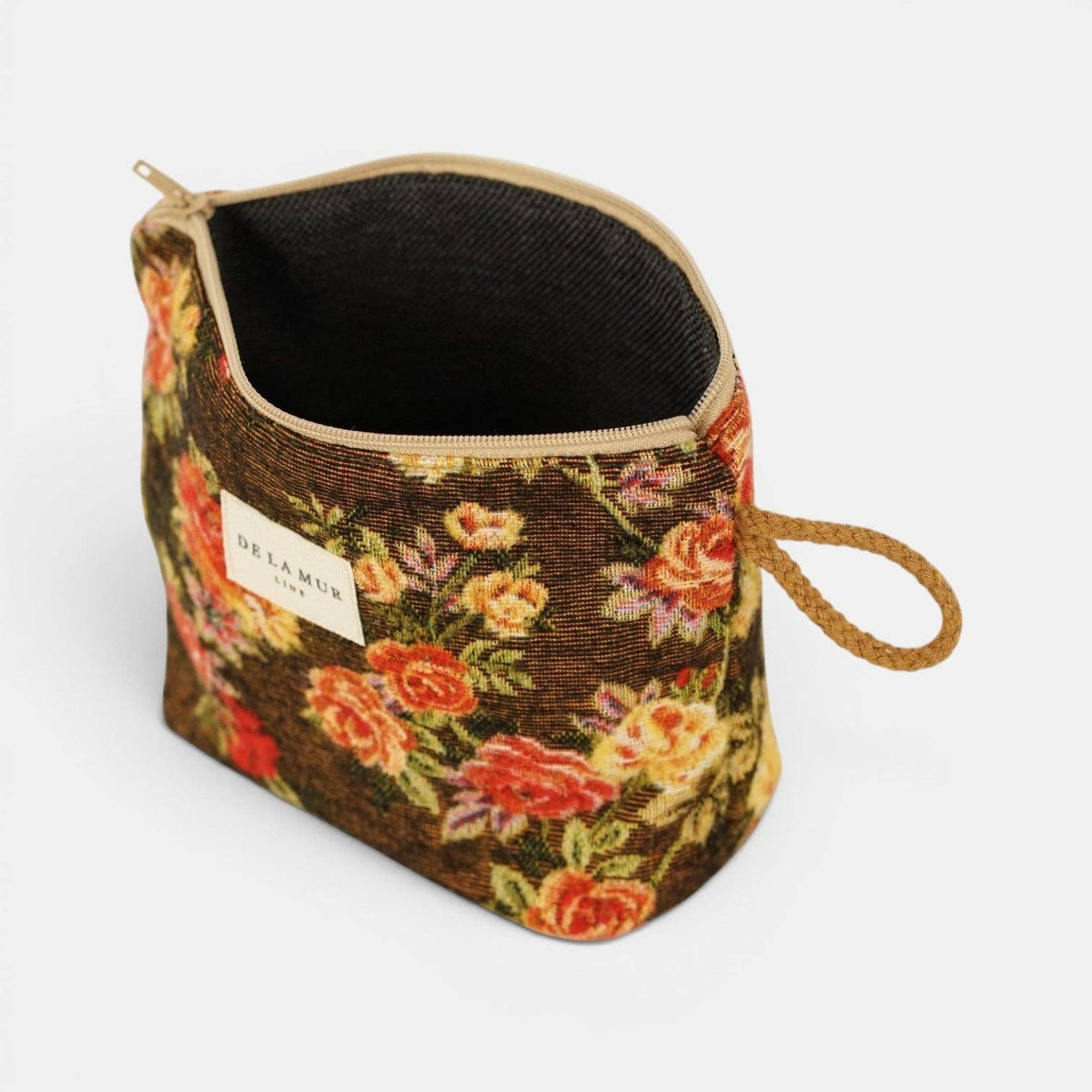 Dark brown and red floral jacquard small makeup bag unzipped to show the dark lining