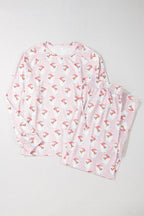 Pink and white striped Christmas pajama set with cherry pattern on a light gray background