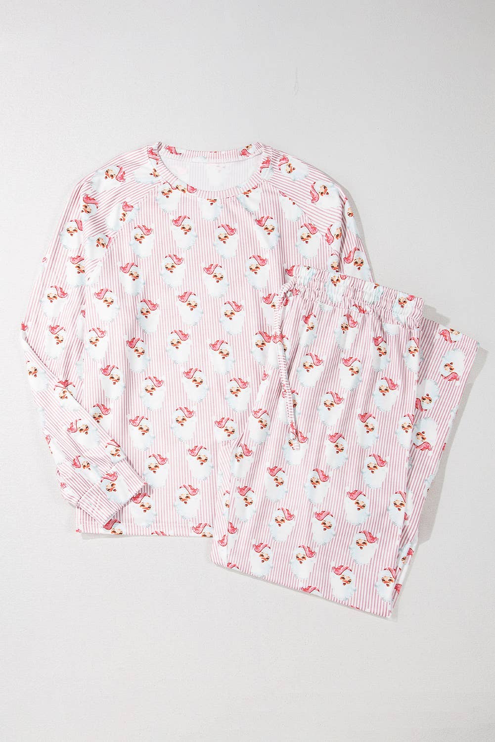 Pink and white striped Christmas pajama set with cherry pattern on a light gray background