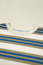 Close-up of a striped crewneck shirt with horizontal beige, white, and blue stripes, featuring a ribbed cream collar.