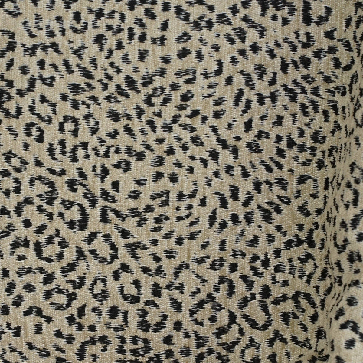 Close-up of the woven black leopard print on beige jacquard