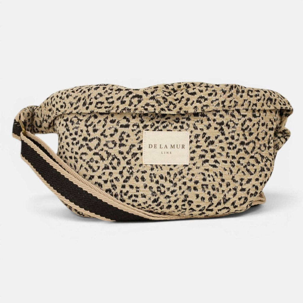 Beige and black leopard jacquard fanny pack with black webbing strap and De La Mur label