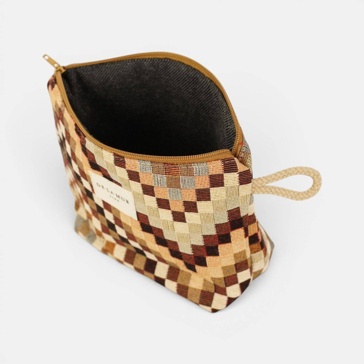 Brown and beige zigzag jacquard small makeup bag unzipped to show the dark lining